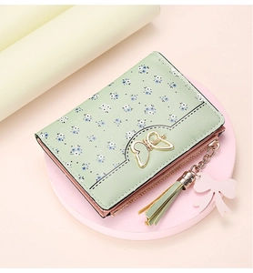 Detailed view of women floral short wallet with butterfly clasp and tassel pendant