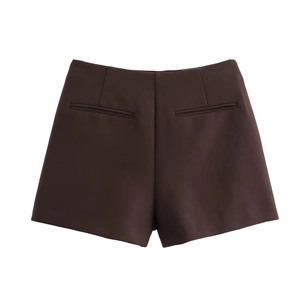 Detail view of high waisted dark brown skort featuring back decorative welt pockets