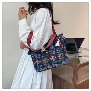 Ethnic style woven shoulder bag with geometric embroidery and colorful tassel details
