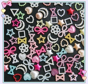Macro shot of colorful ABS heart and star pearls for DIY nail art and craft projects