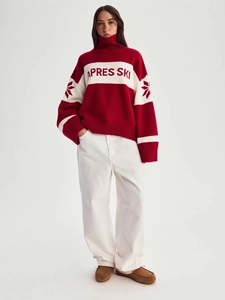 Loose red winter sweater with 'APRES SKI' lettering and snowflake sleeve patterns