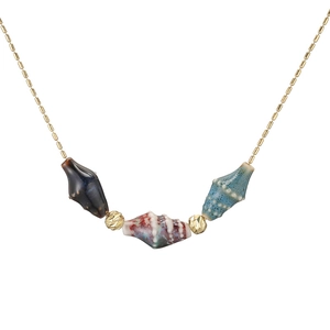 Golden chain necklace featuring colorful ceramic conch shell pendants and faceted beads