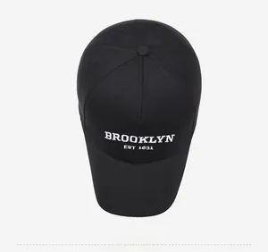 Close-up of a black cotton baseball cap featuring white Brooklyn EST 1631 embroidery