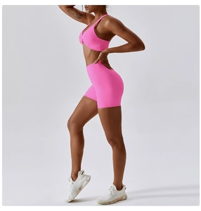 Detail of high-stretch bright pink yoga bra and seamless shorts for women's fitness