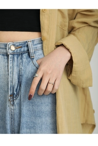 Detail of minimalist S925 sterling silver adjustable rings on model's hand