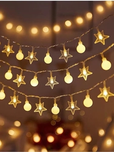 Close-up of warm white star and round LED string lights with soft bokeh background