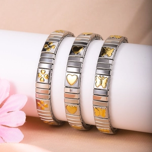 Detail of Italian modular bracelets with gold clover heart and butterfly motifs