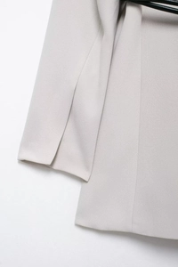 Detail of light gray suit jacket showing textured fabric and clean cuff stitching