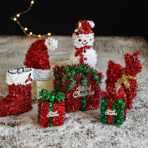 Festive Christmas table decorations with ribbons, snowman, reindeer and LED lights