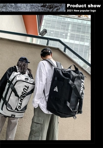 Outdoor shot of large capacity black and white Oxford travel bag with logo detail