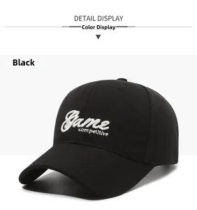 Close-up of white Game competitive embroidery on a black cotton baseball cap