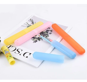 Close-up of portable toothbrush cases in vibrant yellow, pink, blue and orange colors
