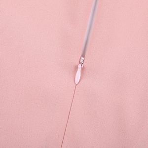 Close-up of a pink concealed zipper on a fashion dress showing fabric texture and detail