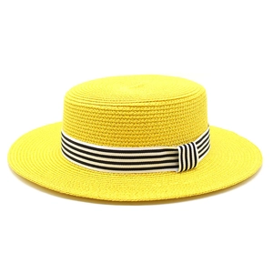 Detail of yellow straw boater hat featuring a classic black and white striped ribbon band