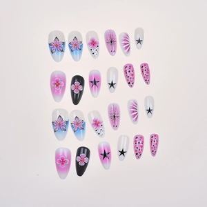 Macro shot of 24pcs almond press-on nails with floral, starry, and polka dot designs