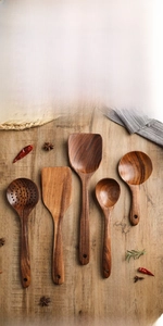 Macro detail of seamless teak wood kitchen tool set with natural grain and hanging hole