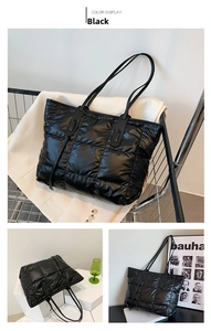 Detail of black quilted down tote bag with leather straps and glossy finish