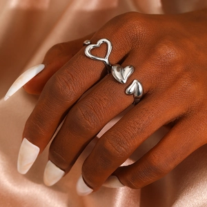 Polished silver heart ring featuring open adjustable design and minimalist aesthetic