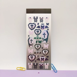 Macro shot of gothic star frosted stickers featuring heart coffin and cross patterns