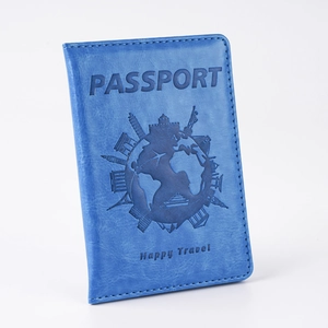 Detail shot of blue PU leather passport cover with debossed world map and landmarks