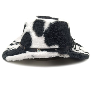 Macro detail of cow print plush cowboy hat with studded leather band and blue stone buckle