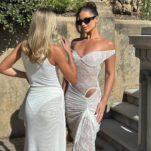 Detail of white lace dress featuring waist cut-outs and a high side slit design