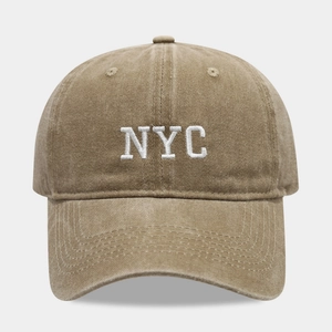 Detail of vintage washed cotton khaki baseball cap featuring white NYC embroidery