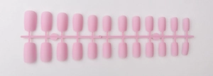 Detailed view of pink long square matte press-on nails displayed on a plastic strip