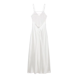 Detail of white satin midi dress showing the cross back straps and silky fabric texture