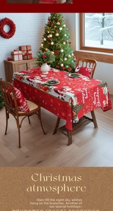 Detail of red Christmas tablecloth and pillowcase with Santa and reindeer motifs