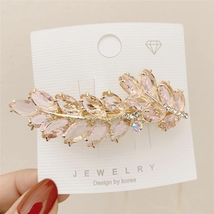 Detail of crystal butterfly hair clip with pink marquise stones and gold alloy base