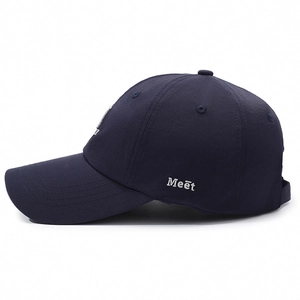 Navy blue baseball cap with Meet embroidery and curved brim in side view profile