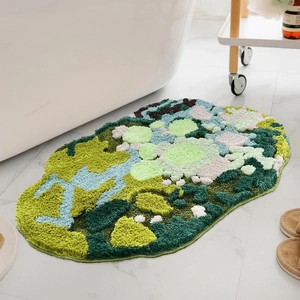 Detailed view of green floral tufted bath mat with plush texture on marble floor