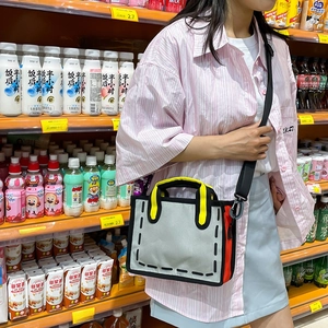 2D cartoon style grey canvas tote bag with red trim and yellow handle in a grocery store