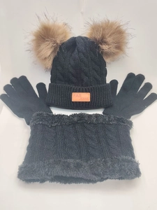 Detailed view of black three-piece knitted set with beanie, neck gaiter, and gloves