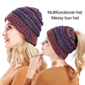 Colorful knit ponytail hat for women featuring a messy bun opening and rainbow yarn design