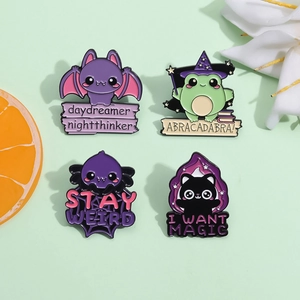 Detailed set of four cartoon enamel pins featuring a magic frog and witch hat on green backdrop