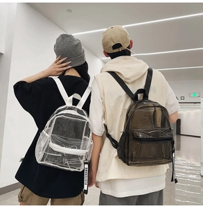 Lifestyle view showing transparent PVC backpack worn by models in modern interior setting