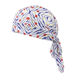 Detail of white paisley bandanna showing colorful geometric patterns and tie-back strings