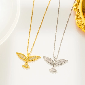 Detailed view of phoenix pendants in gold and silver finish with sparkling rhinestones