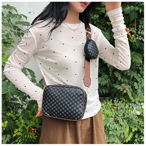 Detail of crossbody camera bag with geometric pattern, leather trim and small coin purse