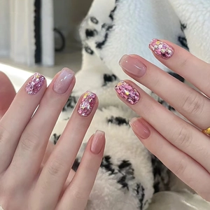Sweet pink cat eye press-on nails with sparkling glitter accents in a short square shape