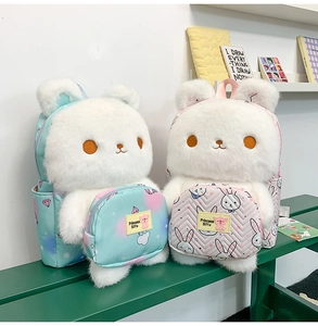 Detail of plush rabbit backpacks in mint green and pink with patterned front pockets