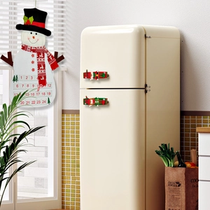 Felt snowman countdown calendar and plush elf handle covers in a festive kitchen
