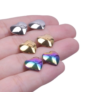 Polished stainless steel heart earrings in silver, gold and rainbow finishes on hand