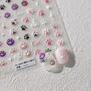 Detailed macro view of 3D embossed cat paw nail stickers with cute heart and star patterns