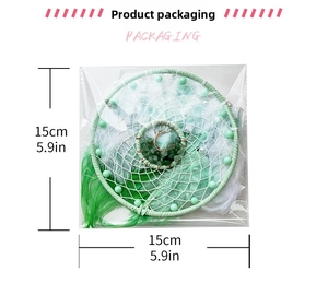 Detail of dream catcher packaging with tree of life crystal and green feathers