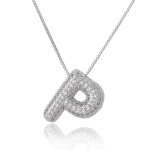 Macro detail of silver-colored letter P pendant with pavé white zircon stones