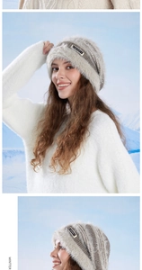 Detail of gray and beige fuzzy knit beanie with black woven label on snowy background