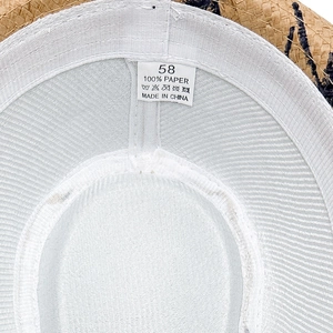 Detailed interior of straw sun hat with sweatband, size tag and breathable mesh lining